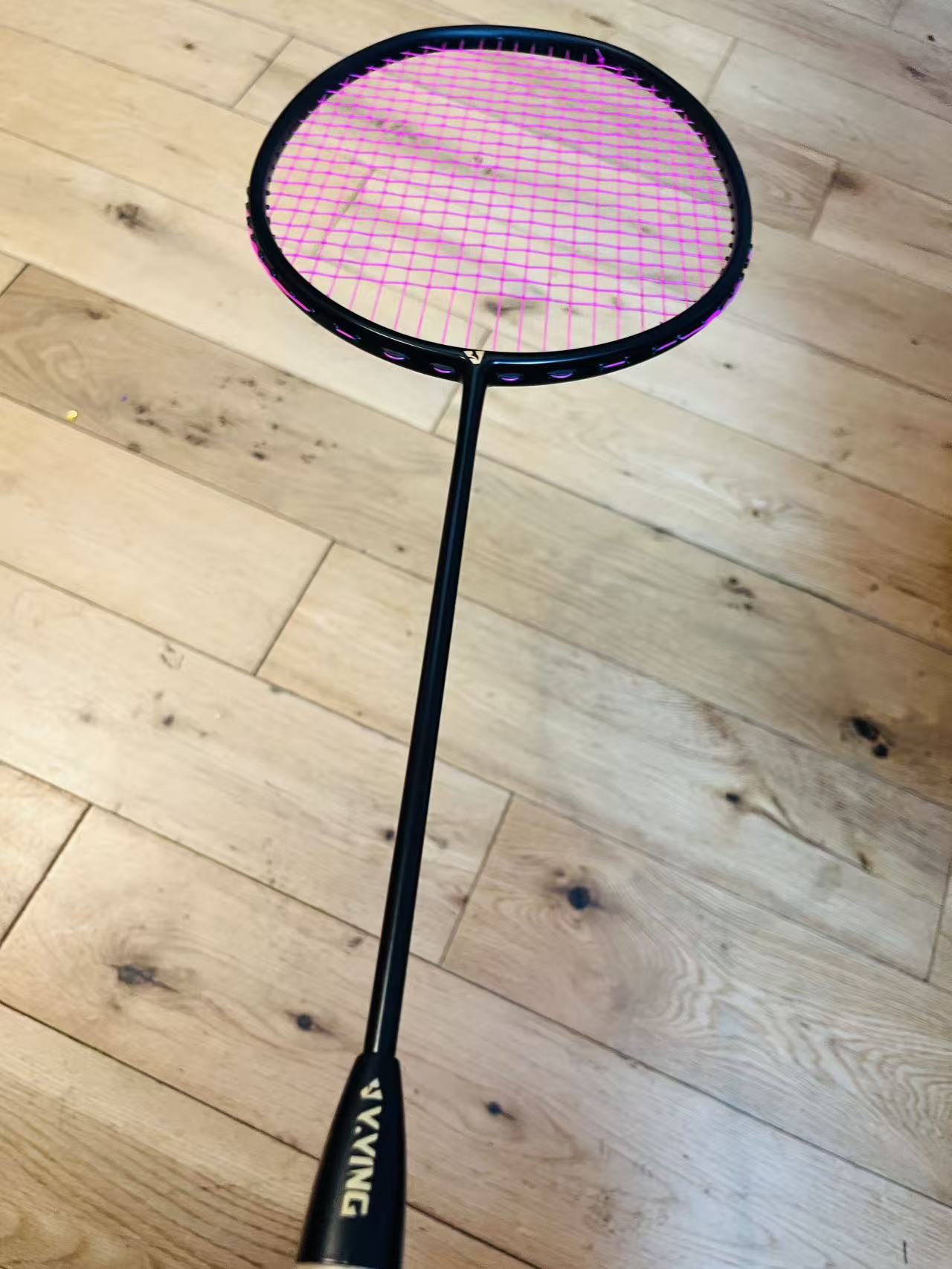 The pure black carbon fiber badminton racket is strung  25 lbs