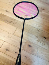 The pure black carbon fiber badminton racket is strung  25 lbs