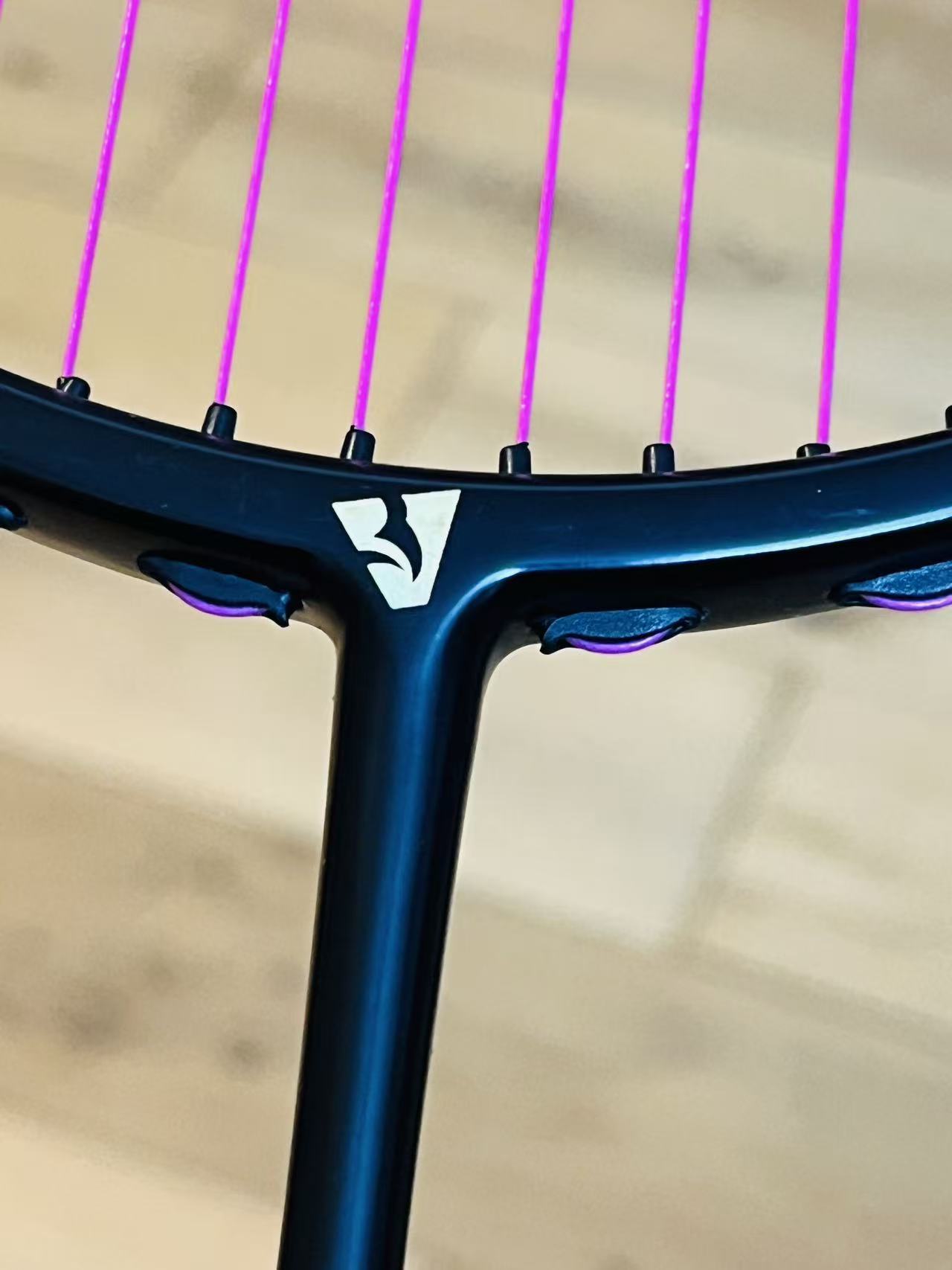 The pure black carbon fiber badminton racket is strung  25 lbs